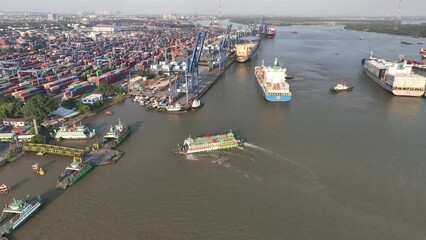 The Cat Lai ferry arrives at the dock to take passengers out in the sunset. 4K stock video Vietnam