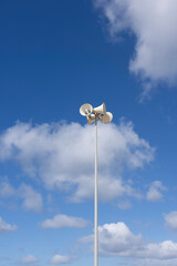 Beach megaphone speaker siren on a sunny day with bright blue sky