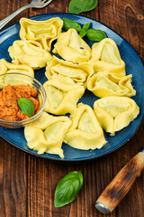 Tortelloni, Italian dumplings on wooden table