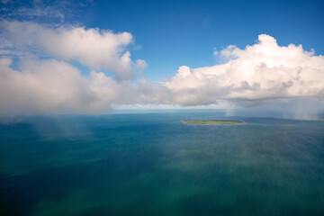 rain falling showers island ocean, aerial view, blue tropical water and sky clouds, travel...