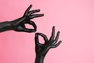Gesticulation of black painted elegant woman's hands on her skin. High Fashion art concept