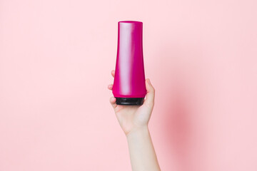 Cosmetic unbranded bottle for shampoo, mask, lotion with pink background. Concept of beauty....