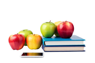 A book with a bunch of apples on top of it. The apples are green, red, and yellow