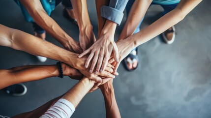 A young people placing their hands together. Friends with stack of hands showing unity and teamwork.