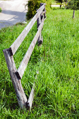 Picket fence on the field border adjoining the country road.