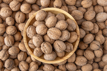 Walnut in shell. Background view from above. Healthy food bowl top view