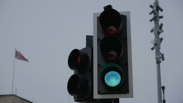 UK road crossing traffic lights from red, amber, green. filmed In busy city street. 