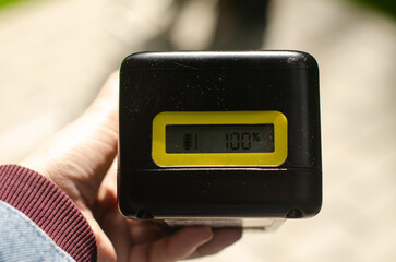 Hand hold the battery for electric cordless lawn mower. High quality photo