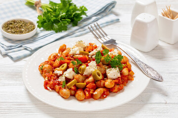 greek giant baked beans with feta, olives on plate