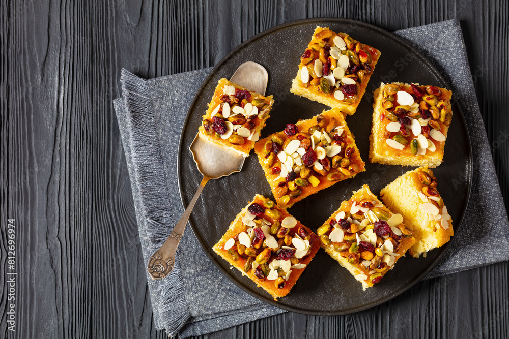 Poster slices of yogurt cake with nuts and dried berries