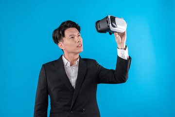 Asian businessman in serious face checking through VR connecting to financial report in futuristic...