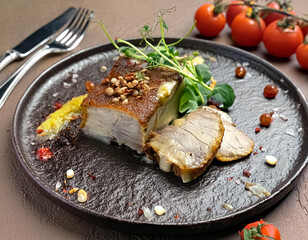 Fried pork with herbs and spices on black stone table. Long banner format