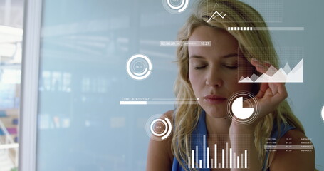 Image of graphs, loading circles, bars, caucasian woman having headache while working on laptop