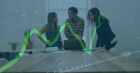 Image of graph with changing numbers over diverse coworkers discussing reports on laptop