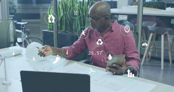 Image icons over african american male architects holding digital tablet and preparing blueprint