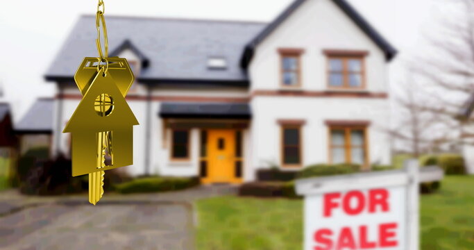 Image of gold house key fob and key, hanging in front of blurred house with for sale sign