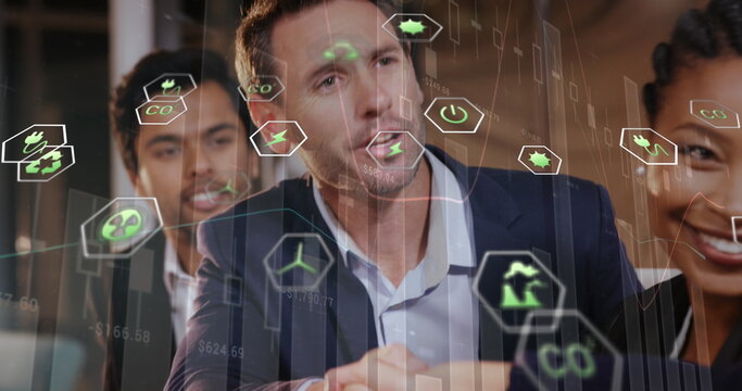 Image of eco icons and data processing over diverse business people in office