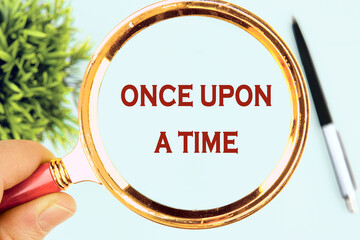 Once upon a time words written through a magnifying glass on a light background
