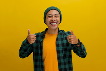 A smiling young Asian man, dressed in casual clothes and wearing a beanie hat, is giving a thumbs...