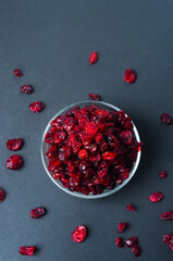 Dried cranberry on dark background flat lay top view