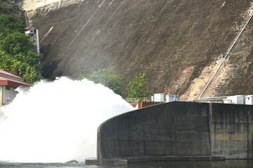 water splashing from floodgate Khun Dan Prakarn Chon huge concrete dam in Thailand