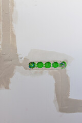 mounted socket outlets in the wall, five pieces, vertical photo