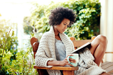 Black woman, reading and coffee for outside in nature, book and backyard or garden for relax. Patio, bench and tea cup for calm and break in home for female person, morning or outdoors in house