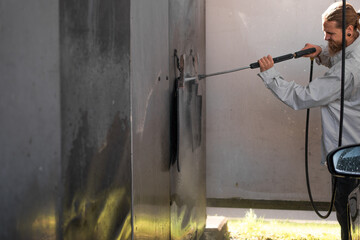 man washes his car at the car wash