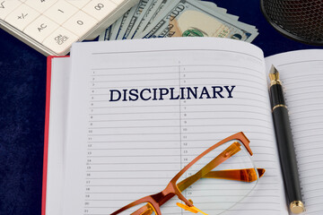 The concept of discipline or ethics word disciplinary written in the businessman's notebook