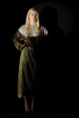 Low key portrait of blonde woman in dress