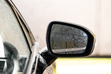 man washes his car at the car wash