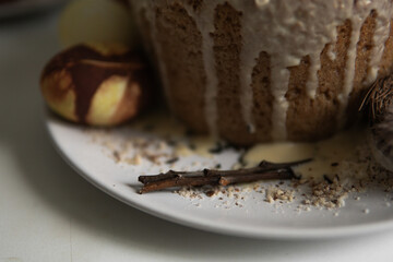 easter cake with chocolate and eggs on a white plate
