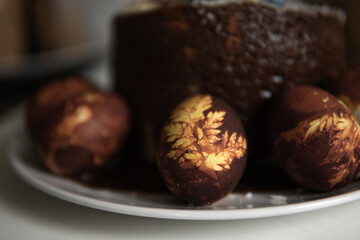 easter cake with chocolate and eggs on a white plate