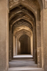 A very large interior with architectural columns with Islamic architecture known as Shabestan in Jame Atiq Mosque in Isfahan city (efahan), Iran