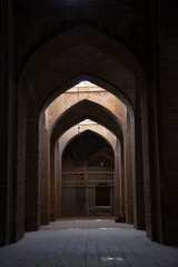 A very large interior with architectural columns with Islamic architecture known as Shabestan in Jame Atiq Mosque in Isfahan city (efahan), Iran