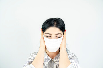 Young woman with surgical mask on face against SARS-CoV-2. COVID-19 Pandemic Coronavirus Young girl...