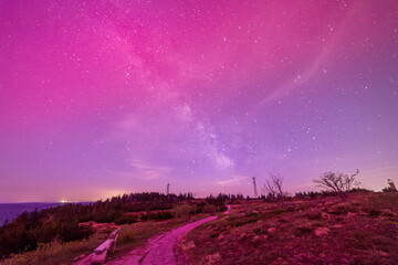 milky way above hornisgride in Baden-württemberg, germany with slight red northern lights on the...