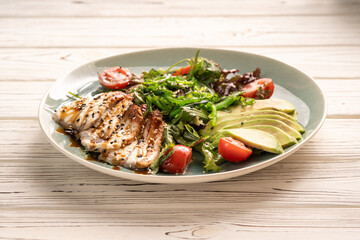 Japanese Cuisine concept. Unagi smoked eel Salad with avocado and Sauce.