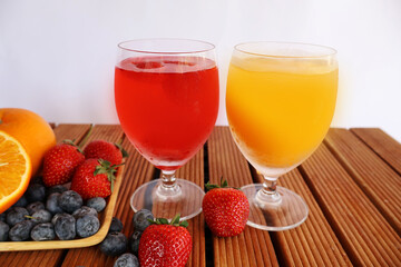 Strawberry and orange juice In glasses placed side by side, various kinds of fruit were placed on a...