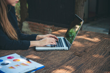 Happiness Asian Woman working from home using laptop online meeting in home office. Happy relax...