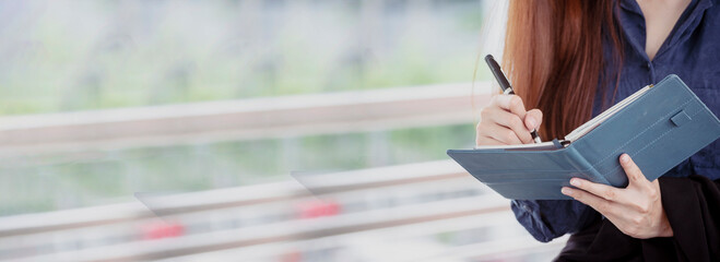 Banner Businesswoman hands writing on notebook meeting agenda in conference room. Banner Woman...