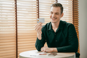 Young man using laptop with credit card for internet banking, online shopping E commerce by online...