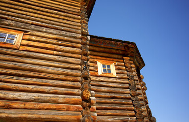 An old wooden building, round timber. The building is made of wood.