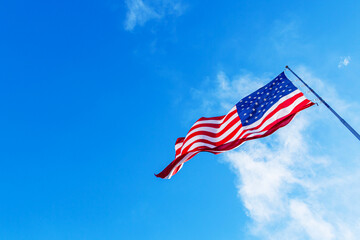 USA American Flag Waving. American Flag blowing in the wind with a blue sky background. USA...