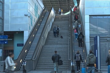 Naklejka premium Stairs and escalator in a train station in Berlin with lots of people.