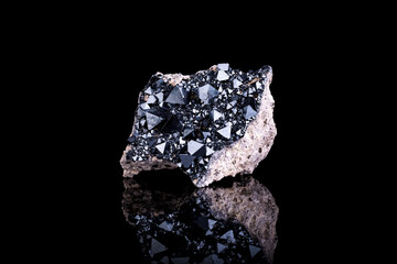 Magnetite crystals on feldspar photography isolated on black blackground. From Cerro Huañaquino,...