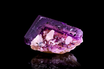 Purple and yellow Fluorite with white calcite photography isolated on black background. From USA. macro detail close-up rough raw unpolished semi-precious gemstone.
