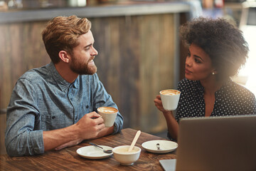 Couple, drinking coffee and happy on date in cafe with conversation, bonding or laptop for online...
