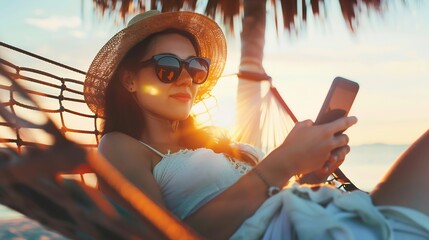 Working remotely Young happy woman female freelancer in straw hat and sunglasses working on smartphone while relaxing in the hammock on the beach at sunset Distance job during vacation : Generative AI
