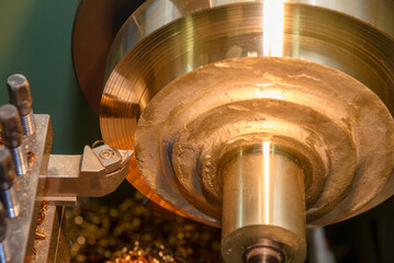 The lathe machine rough cut the brass material parts by lathe tools.